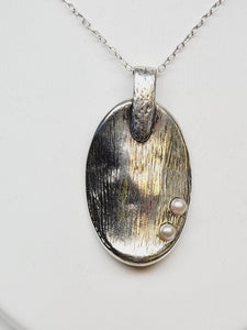 Textured oval pendant necklace with pearl accents